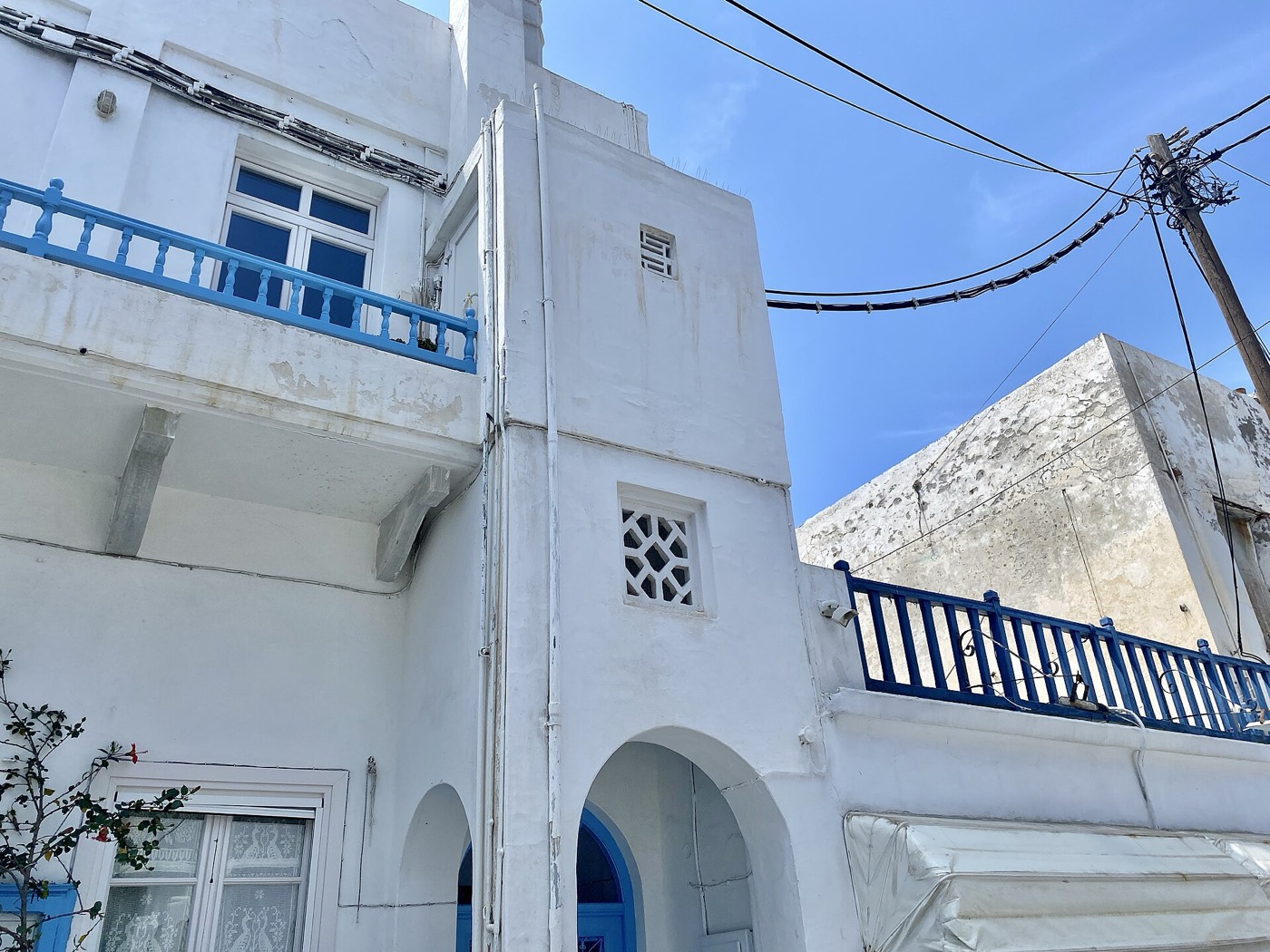 Cubist white house with a blue door in Chora